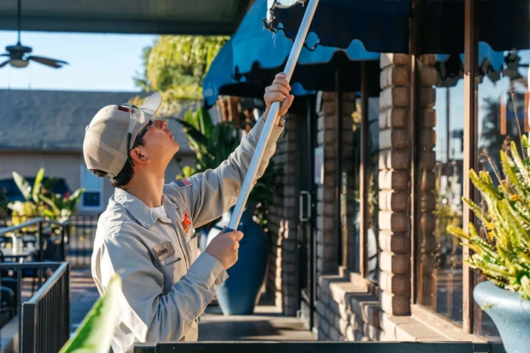 Technician performing quarterly residential pest control treatment